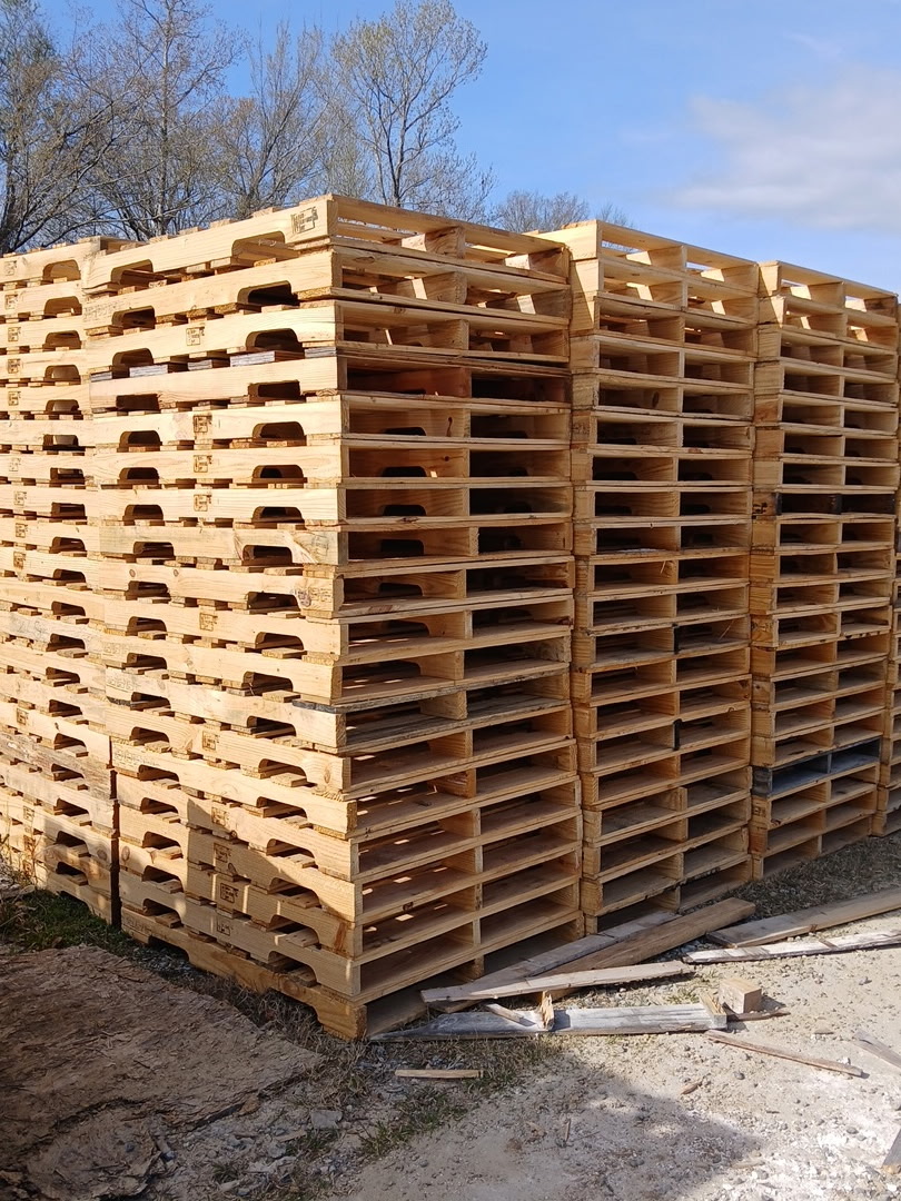 Stacks of wooden commercial pallets at the Gulf Coast Pallet yard